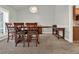 Dining area with wooden table, six chairs, and simple pendant lighting at 4916 Winwood Way, Orlando, FL 32819