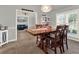 Open-concept dining area with wooden table and chairs, adjacent to living space at 4916 Winwood Way, Orlando, FL 32819