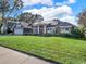 Well-manicured front lawn compliments this one-story home featuring solar panels and an attached garage at 4916 Winwood Way, Orlando, FL 32819
