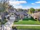 Charming single-story home features an attached garage, well-manicured lawn, and solar panels on the roof at 4916 Winwood Way, Orlando, FL 32819