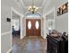 Inviting foyer featuring tile floors, a decorative chandelier, and a wooden double-door entrance at 4916 Winwood Way, Orlando, FL 32819