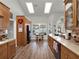 Bright kitchen area boasts wood floors, ample cabinetry, skylights, and backyard views at 4916 Winwood Way, Orlando, FL 32819