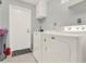 Functional laundry room with modern washer and dryer units and ample storage space at 4916 Winwood Way, Orlando, FL 32819