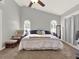 Main bedroom with a ceiling fan, vaulted ceiling, and natural light from arced windows at 4916 Winwood Way, Orlando, FL 32819