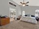 Spacious main bedroom featuring a ceiling fan, connecting bathroom, and bright natural light at 4916 Winwood Way, Orlando, FL 32819