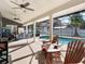 Relaxing outdoor space with a covered patio, ceiling fans, comfortable seating, and a screened-in pool at 4916 Winwood Way, Orlando, FL 32819
