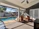 Inviting screened pool patio featuring comfortable seating and a view of the sparkling pool and backyard at 4916 Winwood Way, Orlando, FL 32819