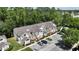 An aerial view shows condo buildings with ample parking surrounded by lush trees at 5005 Laguna Bay Cir # 17, Kissimmee, FL 34746