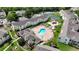 Aerial view of condo community featuring a pool, hot tub, playground and tennis court at 5005 Laguna Bay Cir # 17, Kissimmee, FL 34746