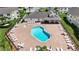 Aerial view showcases pool, hot tub, lounge seating and clubhouse at the villas at 5005 Laguna Bay Cir # 17, Kissimmee, FL 34746