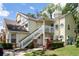 Two-story condo with white stairs and well-maintained landscaping at 5005 Laguna Bay Cir # 17, Kissimmee, FL 34746