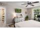 Comfortable main bedroom with an ensuite bathroom, TV and natural light from a window at 5005 Laguna Bay Cir # 17, Kissimmee, FL 34746