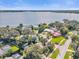 Beautiful aerial view of the neighborhood showcasing mature trees and the lake at 5205 Saint Regis Pl, Belle Isle, FL 32812