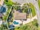 Aerial view of a house featuring a backyard pool, patio, and lush landscaping surrounded by a fence at 5205 Saint Regis Pl, Belle Isle, FL 32812
