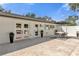 Inviting backyard space with a travertine patio, outdoor seating, and manicured landscaping at 5205 Saint Regis Pl, Belle Isle, FL 32812