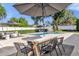 Lovely backyard featuring a dining space, a pool, outdoor seating, and mature trees at 5205 Saint Regis Pl, Belle Isle, FL 32812