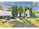 Spacious backyard featuring a fire pit area, lush grass, and a fun play structure at 5205 Saint Regis Pl, Belle Isle, FL 32812