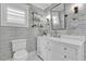 Bathroom featuring a white vanity with marble countertop, decorative wallpaper, and bronze fixtures at 5205 Saint Regis Pl, Belle Isle, FL 32812