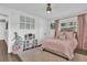 Bedroom with pink accents, hard wood floors, a ceiling fan, and ample natural light at 5205 Saint Regis Pl, Belle Isle, FL 32812