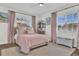 Charming bedroom with hardwood floors, bright windows, and soft, pink decor at 5205 Saint Regis Pl, Belle Isle, FL 32812