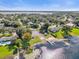 Aerial view of community lake access with boat ramp, grassy area, and dock on a sunny day at 5205 Saint Regis Pl, Belle Isle, FL 32812