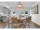 Cozy dining area showcasing wood floors, stylish light fixture, and easy access to the backyard at 5205 Saint Regis Pl, Belle Isle, FL 32812