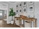 Hallway featuring wood floors, decorative wall paper, and a console table with charming decor at 5205 Saint Regis Pl, Belle Isle, FL 32812