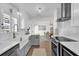 Well-lit kitchen featuring a farmhouse sink, stainless steel appliances, white cabinets with gray lower cabinets at 5205 Saint Regis Pl, Belle Isle, FL 32812