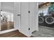 Laundry room with modern washer and dryer units, marble-look flooring, and storage cabinets at 5205 Saint Regis Pl, Belle Isle, FL 32812