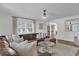 Bright living room with leather seating, decorative wall paneling, modern lighting, and an open floor plan at 5205 Saint Regis Pl, Belle Isle, FL 32812