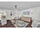 Inviting living room with plush seating, decorative wall paneling, modern lighting, and an open floor plan at 5205 Saint Regis Pl, Belle Isle, FL 32812