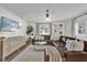 Elegant living room with leather seating, decorative wall paneling, modern lighting, and stylish decor at 5205 Saint Regis Pl, Belle Isle, FL 32812