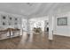 Open-concept living space with wood floors, neutral tones, and easy flow to dining and kitchen at 5205 Saint Regis Pl, Belle Isle, FL 32812