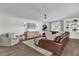 Stylish living room with comfortable seating, decorative wall paneling, modern lighting, and an open layout at 5205 Saint Regis Pl, Belle Isle, FL 32812