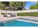 Beautiful pool with outdoor seating, lush landscaping, and a tranquil setting at 5205 Saint Regis Pl, Belle Isle, FL 32812