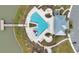 Aerial view of a community pool area with a slide and ample seating near a lake and pier at 5298 Royal Point Ave, Kissimmee, FL 34746