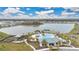 Aerial view of community with swimming pool and other amenities located near a large lake at 5298 Royal Point Ave, Kissimmee, FL 34746