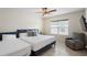 Bright bedroom with ample natural light, tiled floors, a large window and a comfortable chair at 5298 Royal Point Ave, Kissimmee, FL 34746