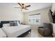 Comfortable bedroom with a plush bed, chair, and mounted TV for relaxation at 5298 Royal Point Ave, Kissimmee, FL 34746