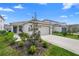 Inviting single-story home with a well-maintained lawn, two-car garage, and charming blue front door at 5298 Royal Point Ave, Kissimmee, FL 34746