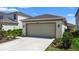 Spacious two-car garage with ample parking space and well-maintained landscaping at 5298 Royal Point Ave, Kissimmee, FL 34746