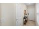Foyer featuring a dark wood table and a round mirror at 5298 Royal Point Ave, Kissimmee, FL 34746