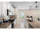 Modern kitchen featuring granite countertops, stainless steel appliances, and stylish pendant lighting at 5298 Royal Point Ave, Kissimmee, FL 34746