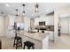 Stylish kitchen with white cabinetry, granite countertops, stainless steel appliances, and seating at the island at 5298 Royal Point Ave, Kissimmee, FL 34746