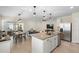 Open kitchen featuring stainless steel appliances, granite counters, and a breakfast bar overlooking the living area at 5298 Royal Point Ave, Kissimmee, FL 34746