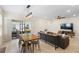 Open-concept living area with tile flooring, modern lighting, and seamless access to the outdoor patio at 5298 Royal Point Ave, Kissimmee, FL 34746