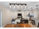Bright living room with modern lighting, tile floors and open floor plan to living room and kitchen at 5298 Royal Point Ave, Kissimmee, FL 34746