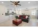 Bright living space featuring tile flooring, an elegant ceiling fan, and comfortable seating next to the kitchen at 5298 Royal Point Ave, Kissimmee, FL 34746