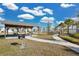 Community park picnic area with picnic tables, a grill, and walkway at 5298 Royal Point Ave, Kissimmee, FL 34746