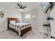 Cozy bedroom featuring a ceiling fan, wall-mounted television, and neutral decor at 5329 Royal Point Ave, Kissimmee, FL 34746